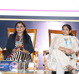 Two panelists seated on stage
