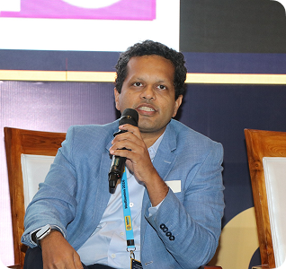 Speaker in blue shirt with microphone